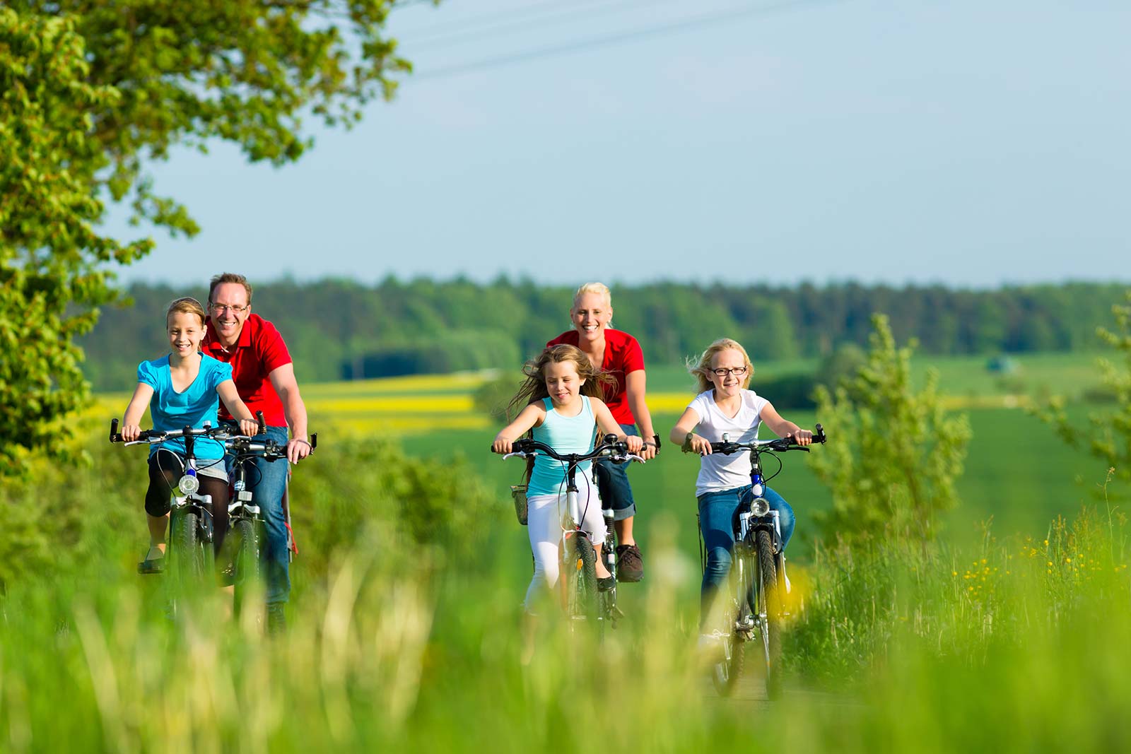 Family of campers on bikes in the countryside in Saint-Hilaire-de-Riez