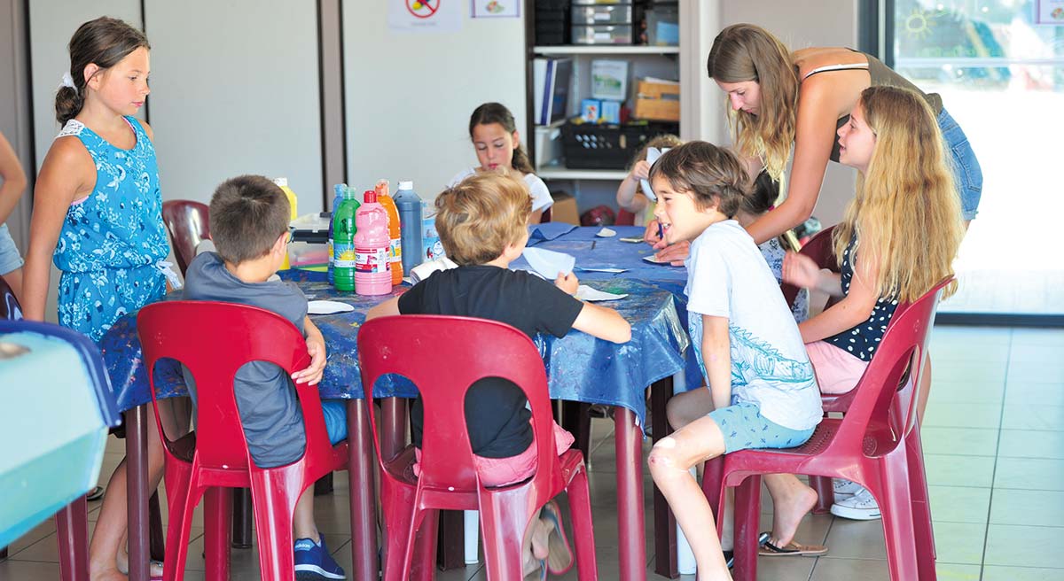 Children seated at the children's club of the campsite near Saint-Jean-de-Monts