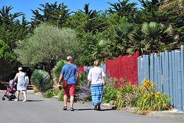 Families on a path leaving the campsite near the shops in Saint-Hilaire-de-Riez