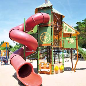 Playground with hut and slide for children at Les Écureuils campsite near Saint-Jean-de-Monts