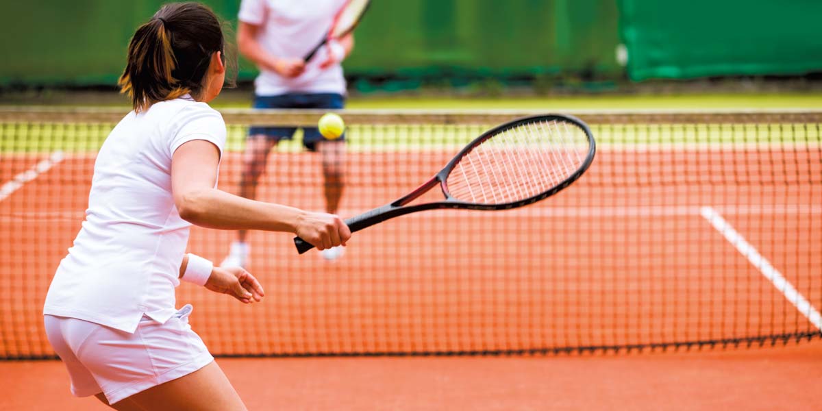 Tennis players on the tennis court of the campsite near Saint-Gilles-Croix-de-Vie